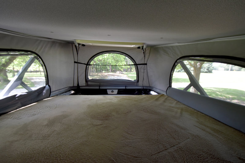 Cozy pop-top bed in an RV rental, offering serene views through mesh windows. Ideal for nature lovers. — photo 8