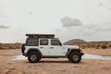 Hit the trails with our white Jeep Wrangler RV rental, complete with a rooftop tent for lakeside Arizona adventures.