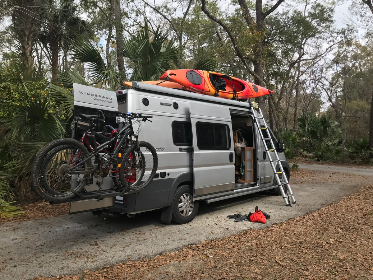  surrounded by rolling mountains.|Explore nature with this RV rental. It's equipped with kayaks