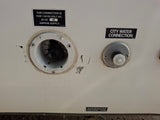 RV rental's external utility panel: 30A electrical input, city water connection, and wastewater tank label clearly visible.