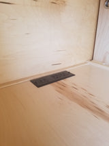 RV rental: Light wood interior with a black power strip, featuring two outlets and two USB ports, built into the surface.