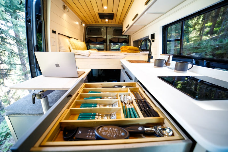  gazing at majestic mountain scenery.|Modern RV rental: Woman enjoys a scenic river view from her camper van's cozy interior — photo 19