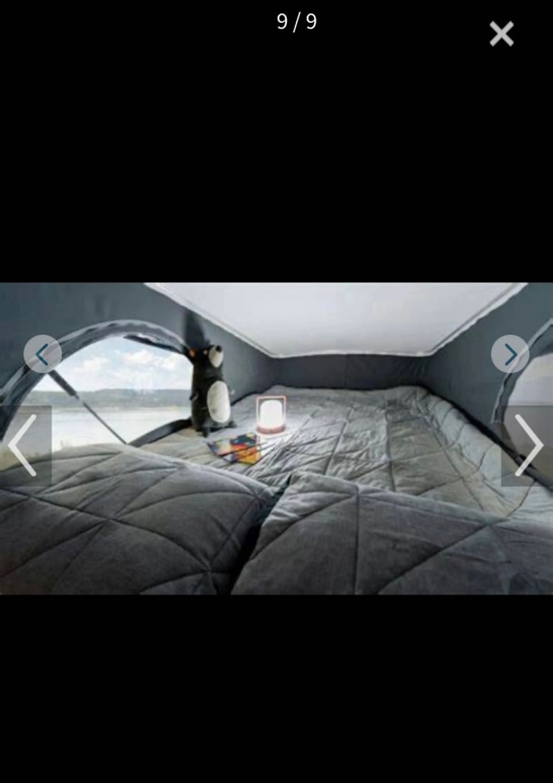 Cozy RV rental pop-top bedroom featuring a comfortable bed, a bright lantern, and a picturesque waterfront view. Perfect for camping! — photo 9