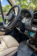 Luxurious RV rental driver's area: Mercedes-Benz dashboard with digital display, power controls, and quilted leather seats.
