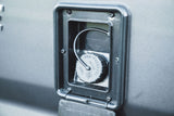 RV rental's non-pressure water fill port with a tethered cap, crucial for clean water supply during camping and travel.