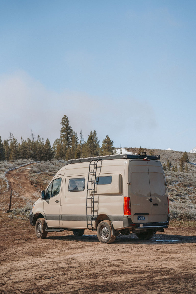 Adventure awaits! Tan Mercedes Sprinter rv rental on a dirt road — photo 1