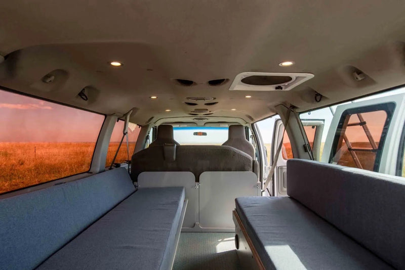  and rear kitchen setup.|White camper van with an open rooftop tent and extended ladder. Ideal for your next outdoor rv rental road trip.|Inside a spacious RV rental campervan — photo 5