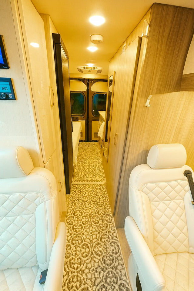  parked lakeside with mountains in the background.|Comfortable RV rental interior: driver's cockpit