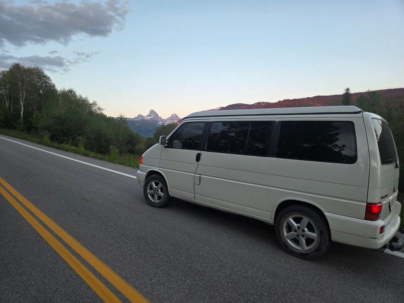 Scenic mountain drive with a white campervan, ideal as an RV rental for road trips, surrounded by nature and peaks. — photo 11