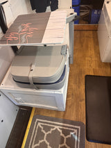Inside an RV rental: Features a flip-up table, comfortable seating cushion, and built-in storage, optimized for small spaces.