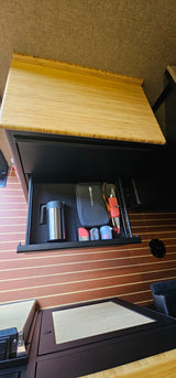 Smart storage in an **RV rental**: a pull-out drawer features a thermos, GSI Outdoors camping kit, and small containers.