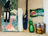 RV rental kitchen drawer: Sponges, dish soap, spices, lighter, bags, can opener, and towels organized.