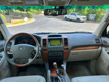 Lexus GX interior, dashboard with navigation. Road ahead with a truck. Consider an RV rental for future trips.