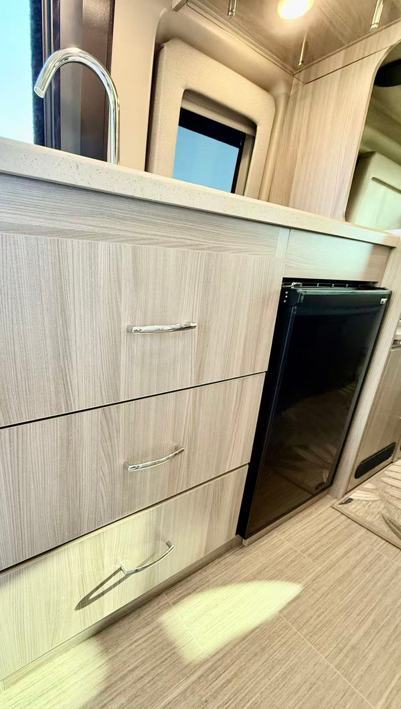 leading to an expansive ocean and beach view.|Explore this modern RV rental interior with cream seats — photo 11