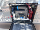 An rv rental's exterior compartment with a Thetford toilet cassette, TST treatment, and gloves for waste tank sanitation.