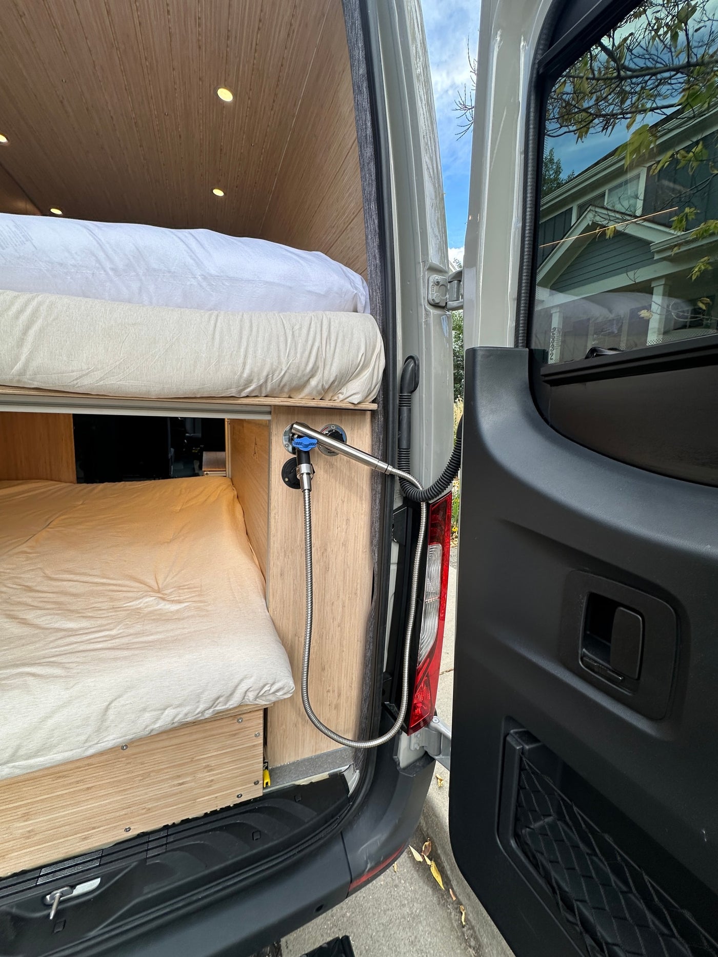  perfect for adventure.|RV rental van interior featuring a cozy bed — photo 3