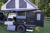 This off-road camper trailer, ideal for an rv rental, features a pop-up tent and a convenient outdoor kitchen for exploring.