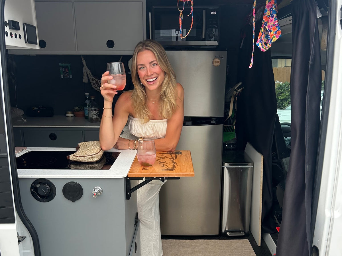  with outdoor chairs set for a perfect campervan evening.|Enjoying a charcuterie snack board inside an RV rental — photo 9