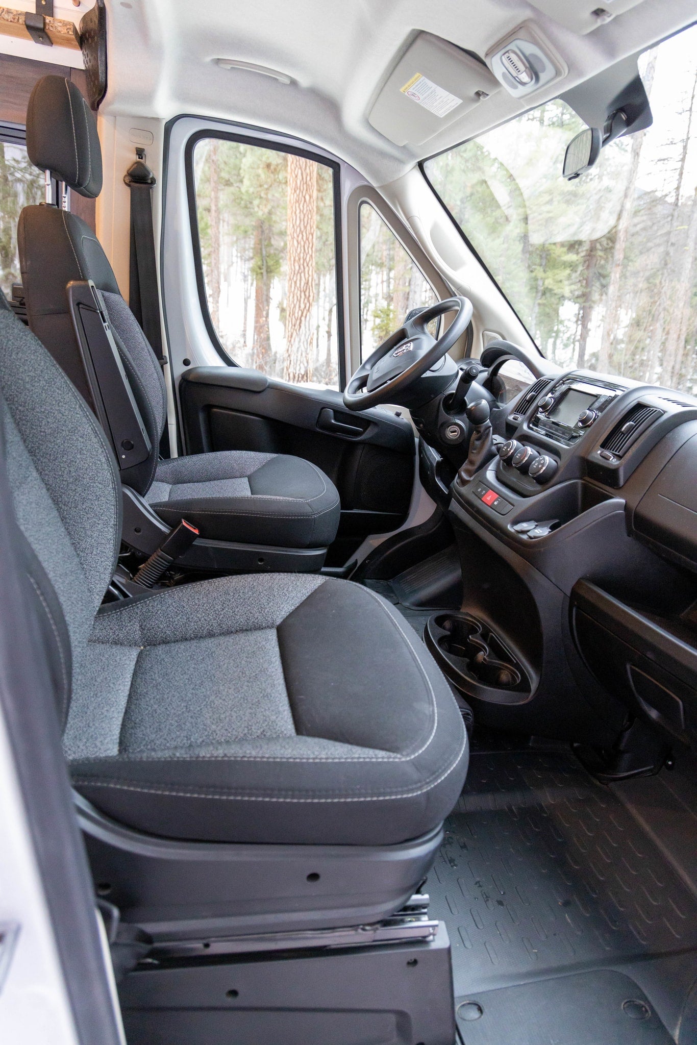  and storage.|Compact RV rental interior with a comfy bed — photo 18