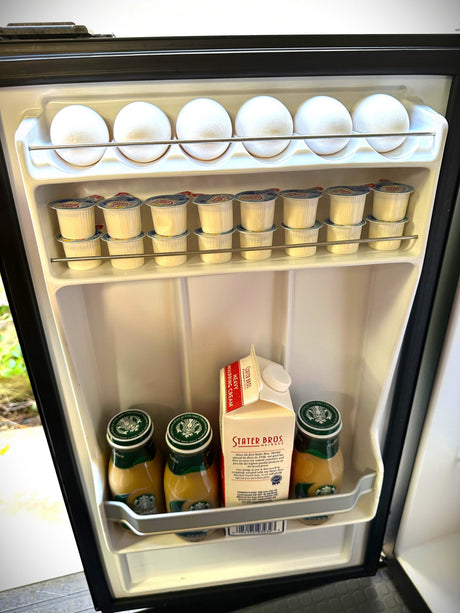 An organized RV rental mini-fridge. It holds 8 eggs, stacked coffee creamers, Starbucks bottled coffee, & whipping cream.