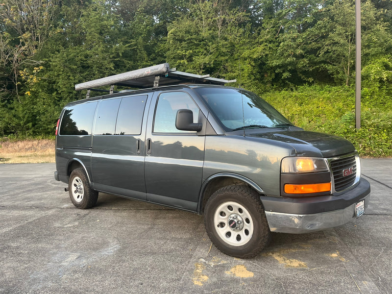 Grey GMC converted van with roof rack & awning. Perfect for your next RV rental adventure. — photo 11