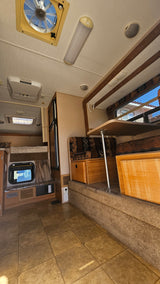 Step inside this RV rental! Features include a cozy dinette, a bunk bed, fridge, and AC. Your next adventure awaits.