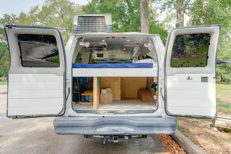  and outdoor table with power unit.|White camper RV rental with side awning — photo 3