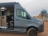 The interior of this Winnebago rv rental is ready for adventure, parked beside a huge blue dinosaur.