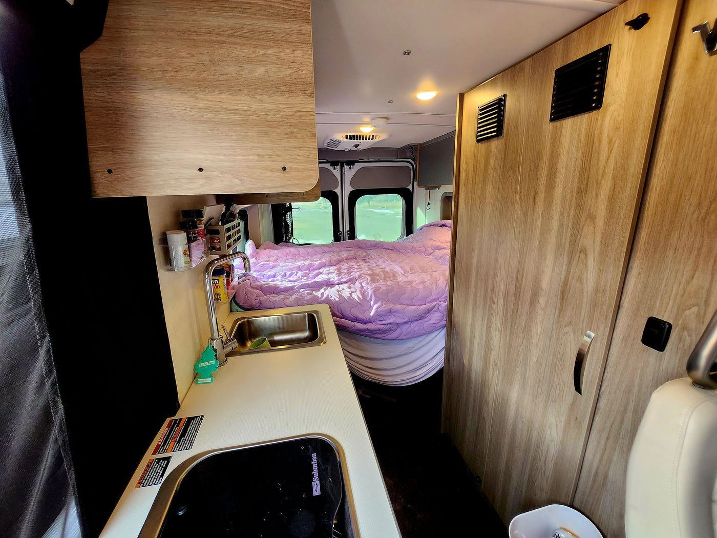  ideal for an RV rental or a fun road trip.|Cozy rv rental interior showing a compact kitchen with sink — photo 1