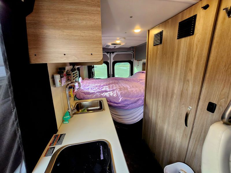  ideal for an RV rental or a fun road trip.|Cozy rv rental interior showing a compact kitchen with sink — photo 1