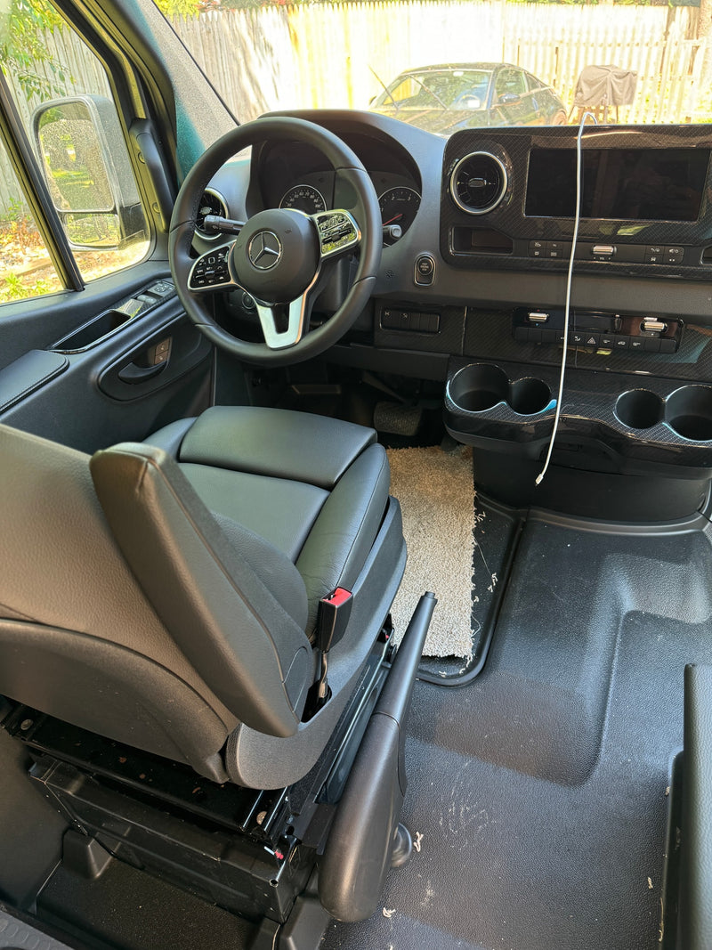 Inside a Mercedes-Benz van RV rental: driver's area featuring a modern dashboard, steering wheel, and black leather seat. — photo 18