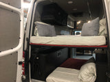 RV rental camper van interior with clever bunk beds, overhead storage, and a built-in shower, optimizing mobile living space.