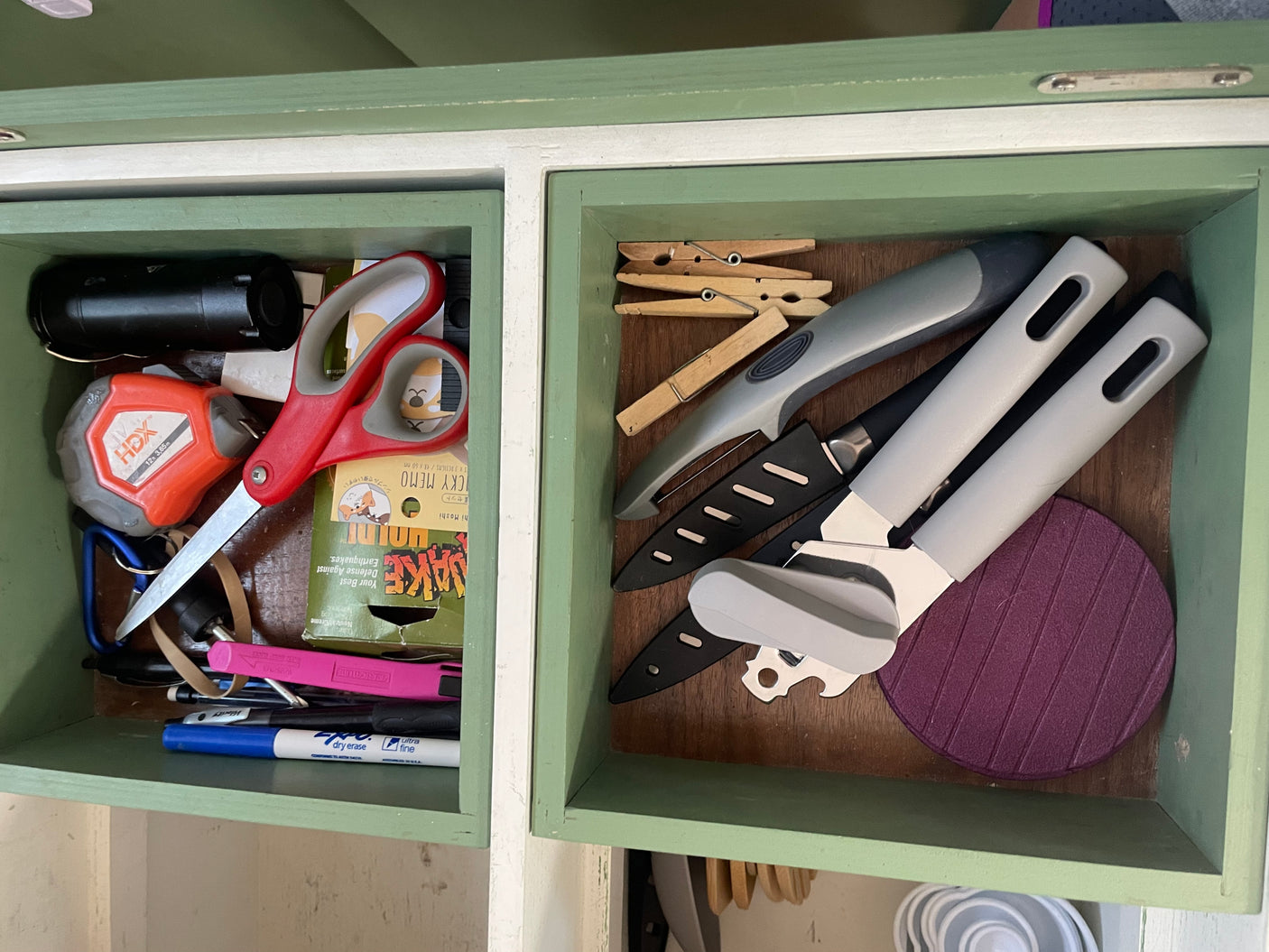 Inside an **RV rental**, compact, organized cubbies hold utility tools like scissors & knives, plus kitchen gadgets and sticky notes.