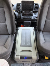 An optional portable electric cooler can be set to be a freezer or refrigerator. It sits between the two front seats when they are swiveled. Travels elsewhere in the van when driving.