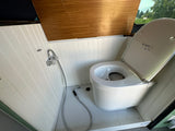 This RV rental offers a practical bathroom with a Separett composting toilet and a flexible shower setup.