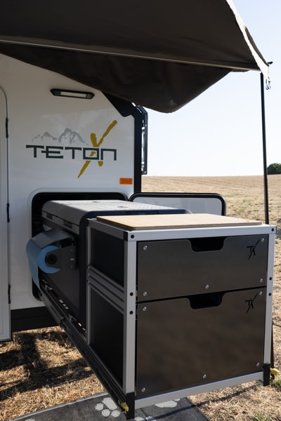 Outdoor kitchen setup on a Teton X RV rental. Perfect for camping meals with pull-out storage and prep space. — photo 8