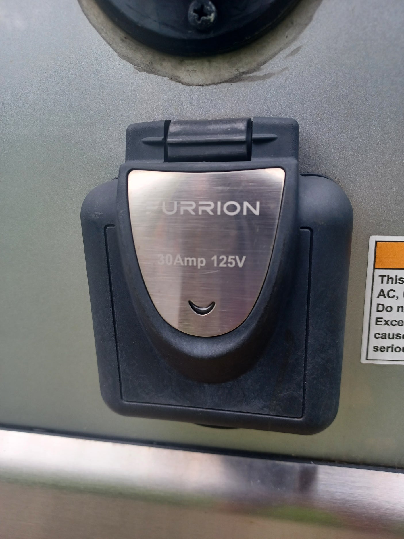 A FURRION 30Amp 125V RV power inlet, essential for connecting to shore power during your rv rental trip.