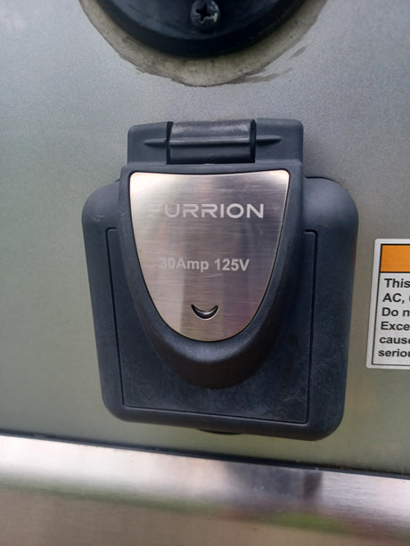 A FURRION 30Amp 125V RV power inlet, essential for connecting to shore power during your rv rental trip.