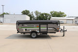 Gray Rockwood Freedom pop-up camper, an ideal RV rental option, parked on a paved lot for your next adventure.