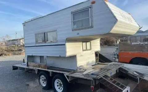 Cab over camper on flat bed trailer