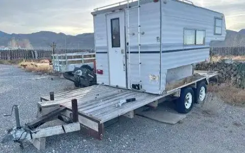 Cab over camper on flat bed trailer